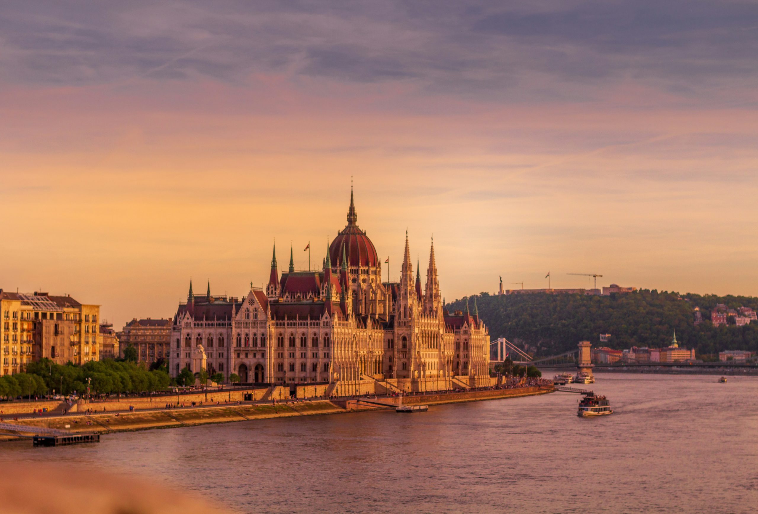 Europe river cruise planning view of the Danube River and Hungarian Parliament at sunrise.